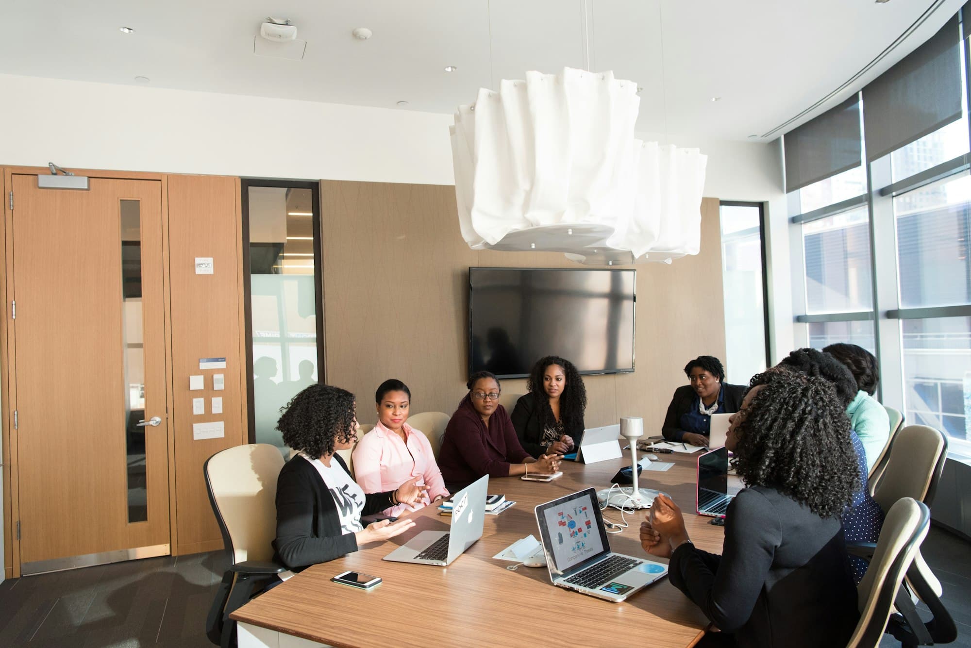 Black-led inventory operations team reviewing analytics in a meeting